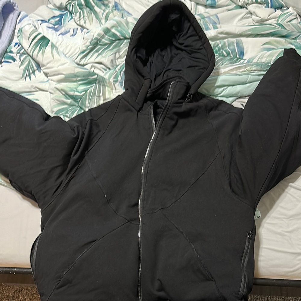 Black Hooded Puffer Jacket with Full-Length Zipper.